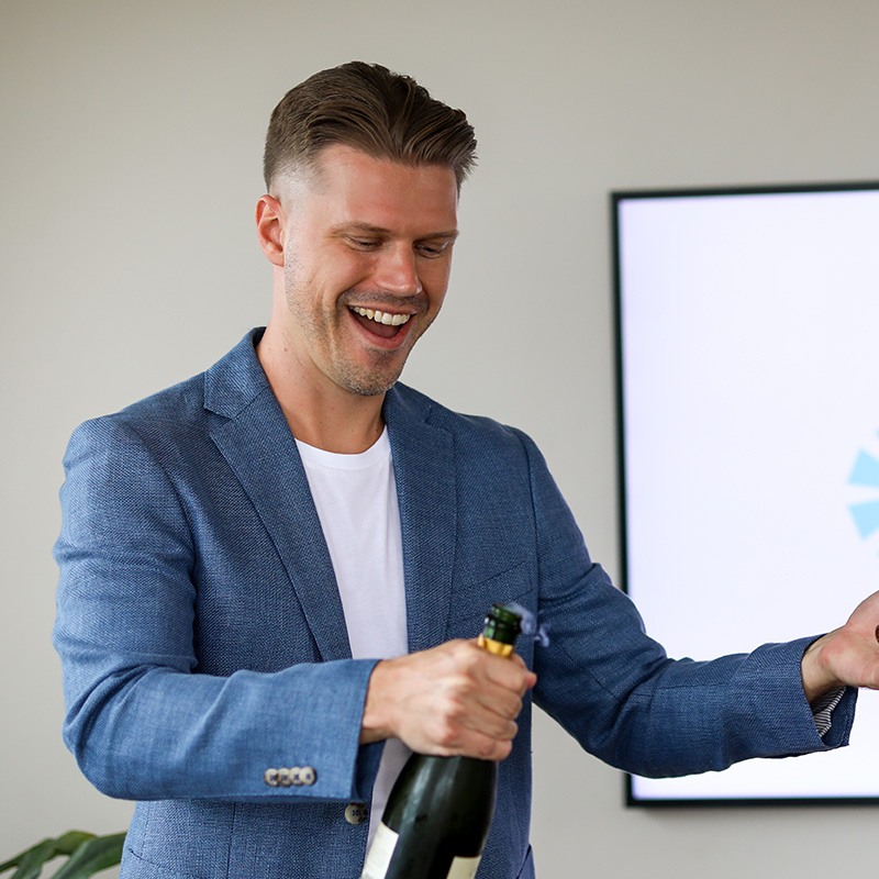 Ariel popping champagne at the Increate launch